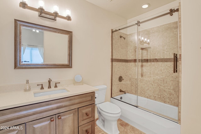 full bathroom with vanity, tile patterned flooring, toilet, and enclosed tub / shower combo