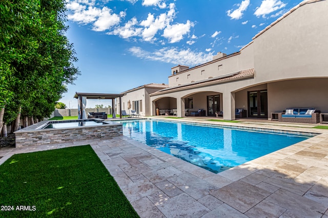 view of swimming pool featuring a yard, an outdoor hangout area, an in ground hot tub, and a patio area