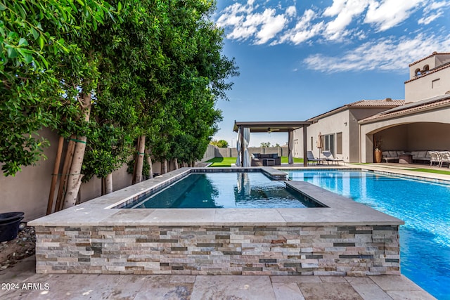 view of pool featuring an in ground hot tub and a patio