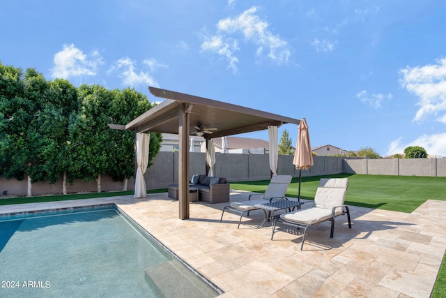 view of pool featuring ceiling fan, outdoor lounge area, a yard, and a patio