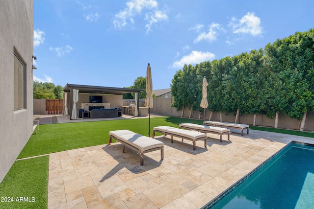 view of patio / terrace featuring outdoor lounge area, a fenced in pool, and an outdoor kitchen