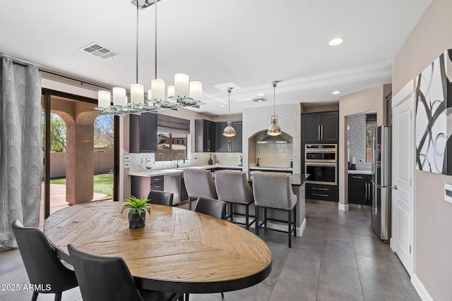 dining area with tile patterned floors, visible vents, and recessed lighting