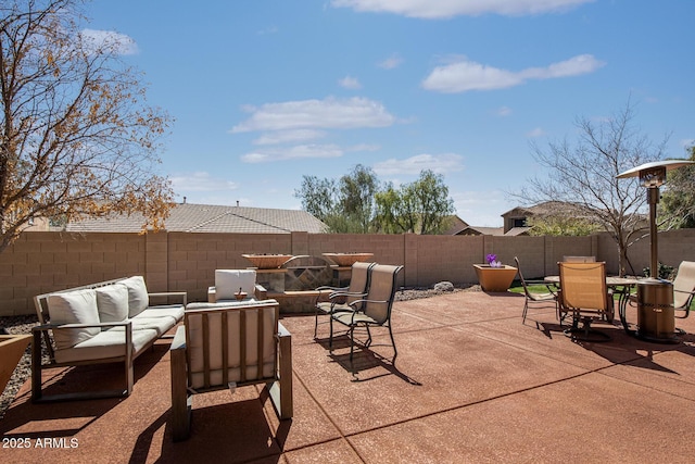 view of patio featuring outdoor dining area, outdoor lounge area, and a fenced backyard