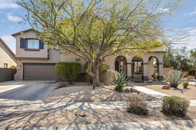 view of front of home featuring an attached garage, driveway, fence, and stucco siding