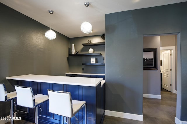 bar featuring pendant lighting and baseboards