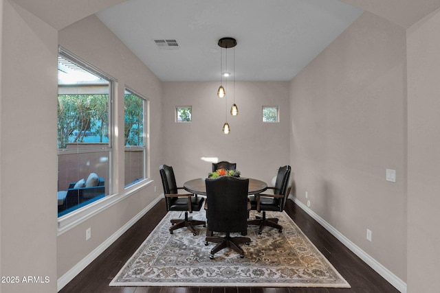 dining area with dark hardwood / wood-style flooring