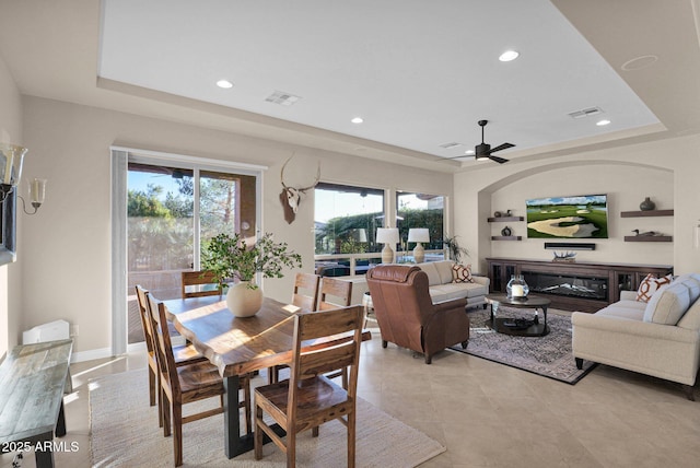 dining space featuring a tray ceiling and ceiling fan