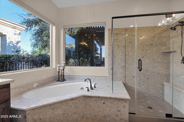 bathroom with vanity and independent shower and bath