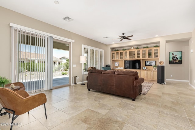 living room with baseboards, visible vents, a ceiling fan, and recessed lighting