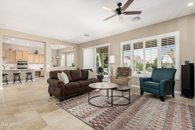 living room with ceiling fan, recessed lighting, visible vents, and baseboards