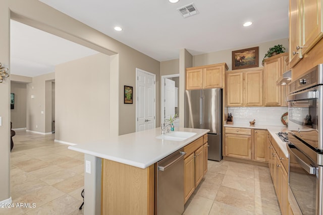 kitchen with light countertops, an island with sink, a sink, and stainless steel appliances