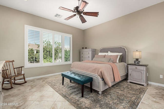 bedroom featuring light tile patterned floors, baseboards, visible vents, and ceiling fan