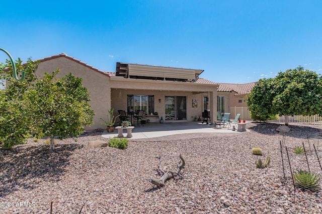 back of property featuring a patio area, fence, a tile roof, and stucco siding