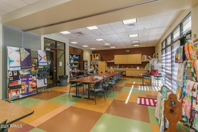 dining space featuring a drop ceiling, visible vents, and tile patterned floors