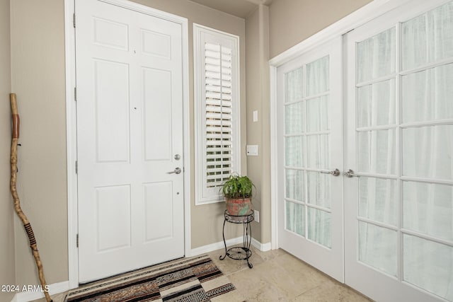 entrance foyer with french doors and baseboards