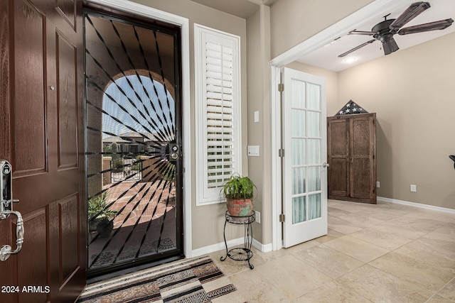 interior space with ceiling fan and baseboards