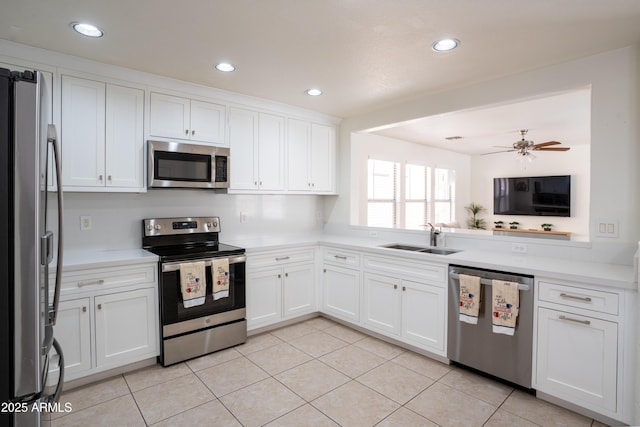 8516 N 64th Ave, Glendale, AZ 85302 - kitchen with stainless steel appliances, a sink, white cabinetry, recessed lighting, and light tile patterned floors