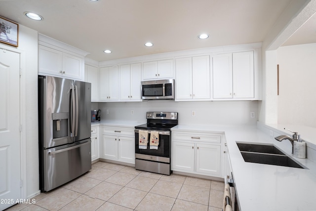 8516 N 64th Ave, Glendale, AZ 85302 - kitchen featuring stainless steel appliances, a sink, light tile patterned floors, light countertops, and white cabinetry