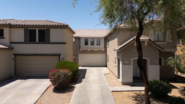 8516 N 64th Ave, Glendale, AZ 85302 - view of front of house with concrete driveway, stucco siding, an attached garage, and a tile roof