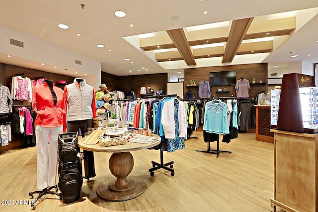 interior space with beamed ceiling, coffered ceiling, and light wood-type flooring