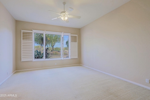 unfurnished room with ceiling fan and light colored carpet