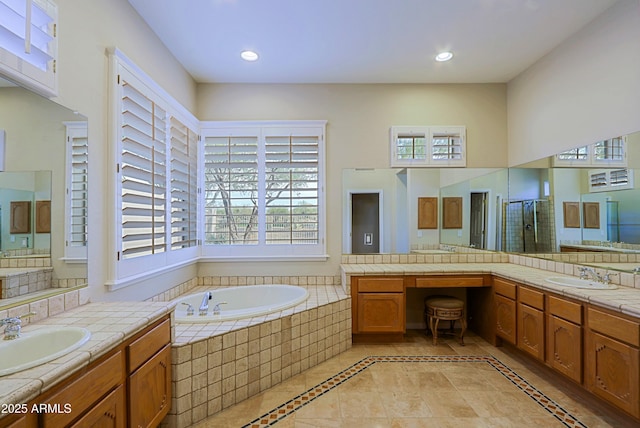 bathroom with vanity and independent shower and bath