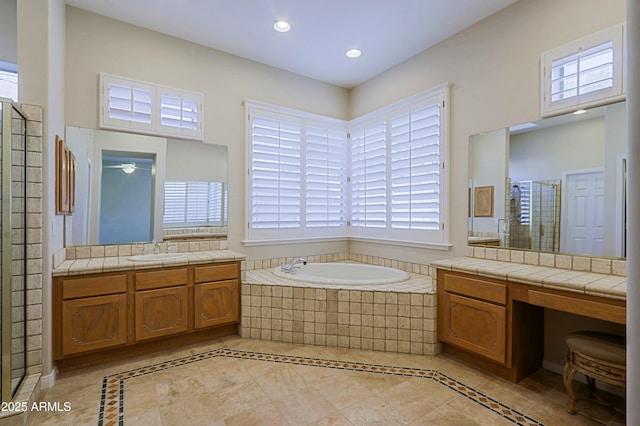 bathroom featuring vanity and independent shower and bath