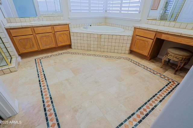 bathroom with vanity and tiled bath