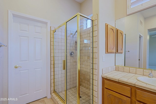 bathroom featuring vanity and a shower with door