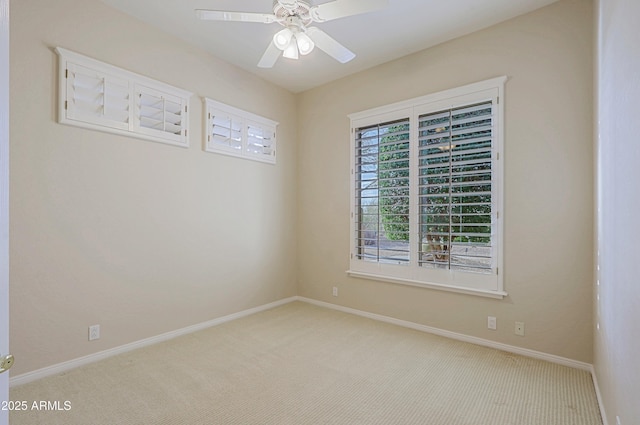 carpeted spare room featuring ceiling fan