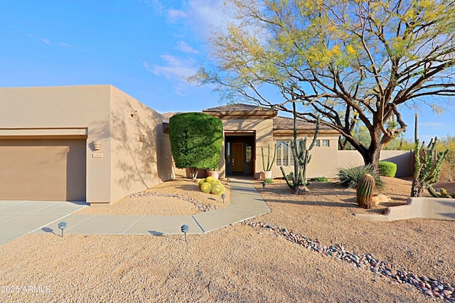 adobe home featuring a garage