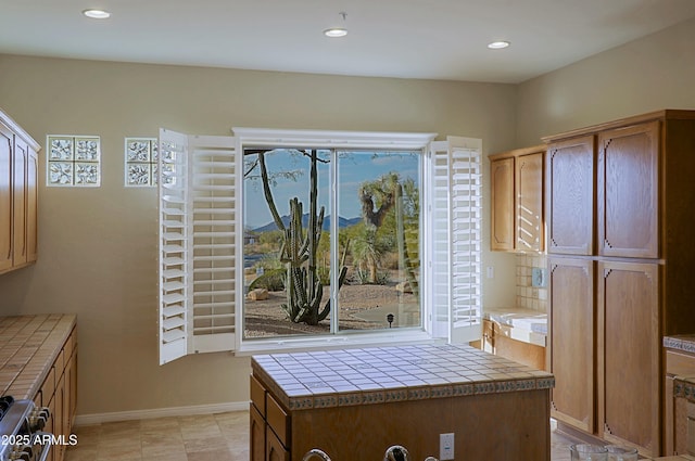 kitchen with tile countertops and stainless steel range oven