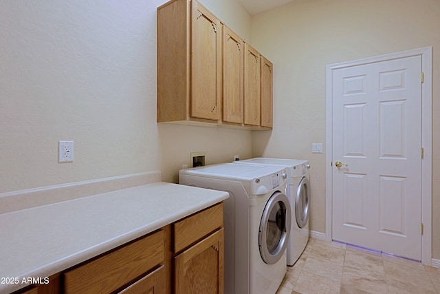 washroom with separate washer and dryer and cabinets