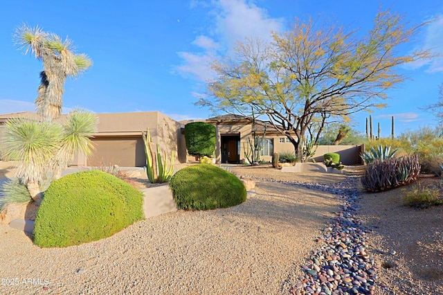 adobe home featuring a garage