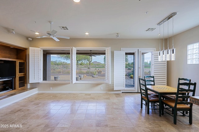 tiled dining area with ceiling fan