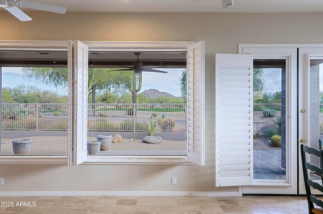 doorway featuring a healthy amount of sunlight and ceiling fan