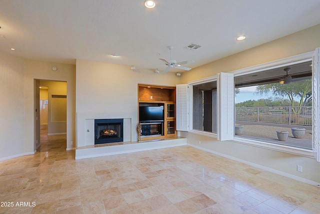 unfurnished living room with ceiling fan