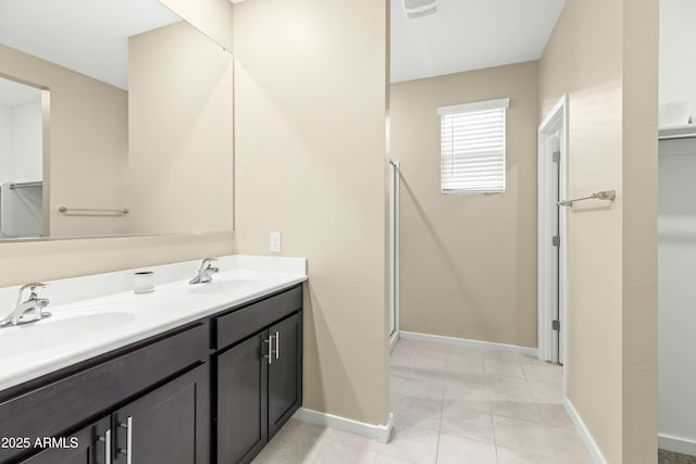 bathroom with vanity, tile patterned floors, and a shower with door