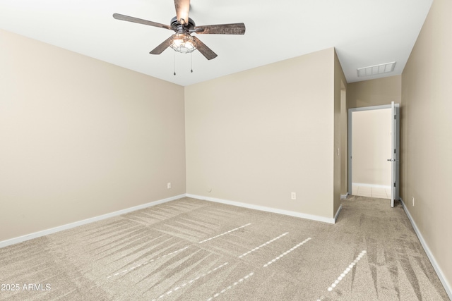 carpeted spare room featuring ceiling fan