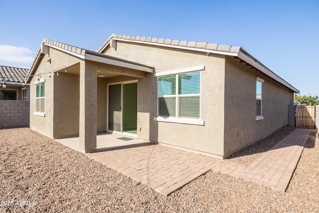 rear view of property featuring a patio area