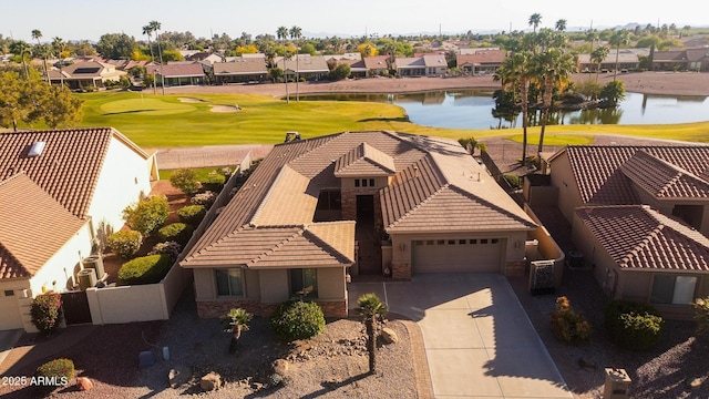 drone / aerial view with a residential view, a water view, and view of golf course