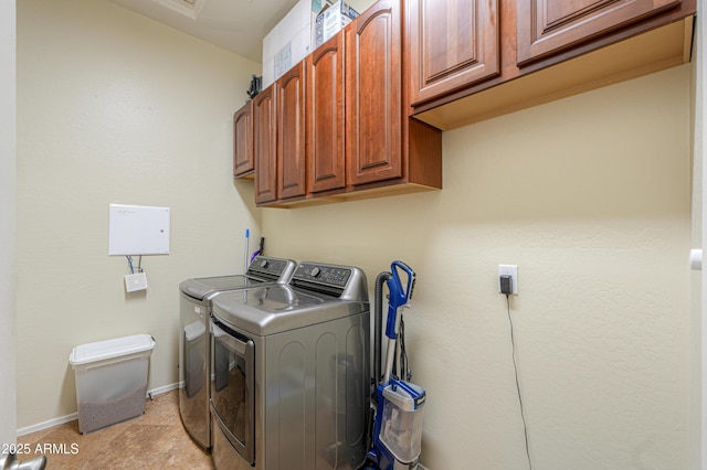 laundry area with cabinet space, washing machine and clothes dryer, and baseboards