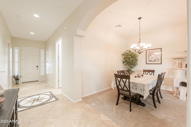dining room with an inviting chandelier, arched walkways, visible vents, recessed lighting, and baseboards