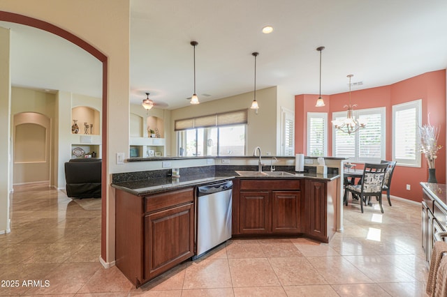 kitchen with visible vents, stainless steel dishwasher, arched walkways, built in shelves, and a sink