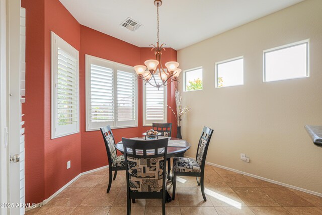 dining room with a notable chandelier, light tile patterned floors, visible vents, and baseboards