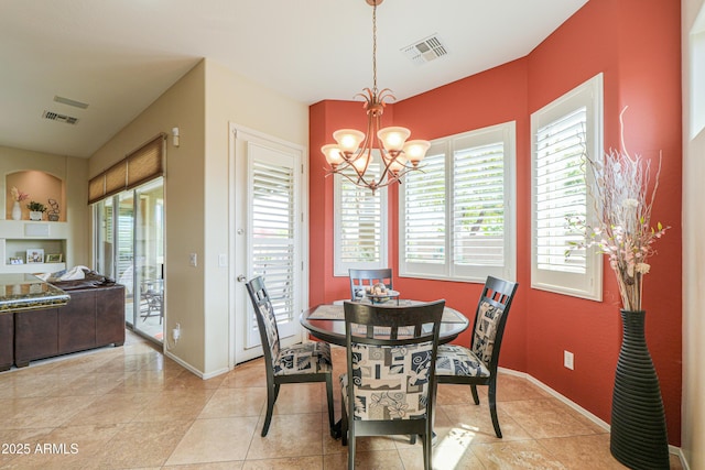 dining room featuring a notable chandelier, light tile patterned floors, visible vents, and baseboards