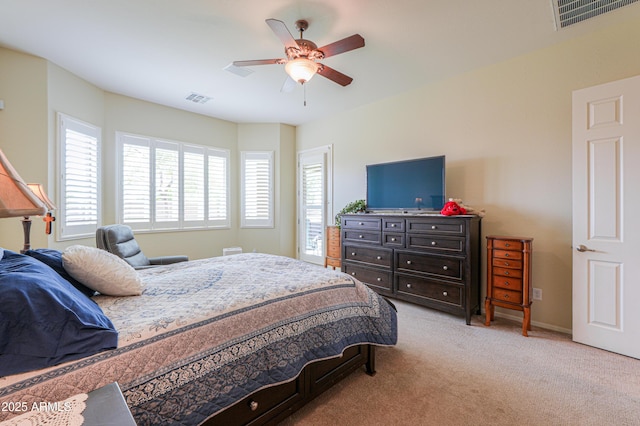 bedroom with baseboards, light colored carpet, ceiling fan, and visible vents