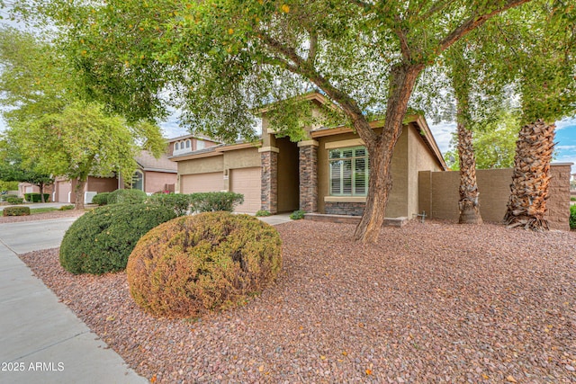 view of front of home with driveway, stucco siding, and an attached garage