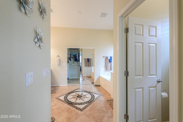 hallway with light tile patterned floors and visible vents