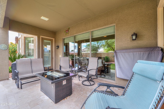 view of patio / terrace with fence and an outdoor living space with a fire pit